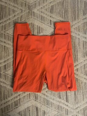 Vuori Women's High-Waist Leggings in Orange